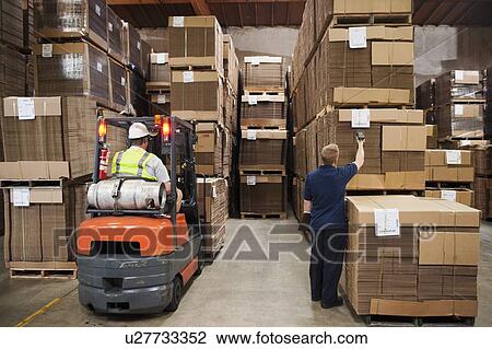Stock Image - People working in warehouse. Fotosearch