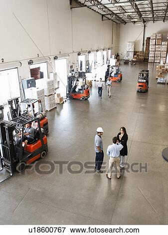 Stock Photo - People working in warehouse. Fotosearch