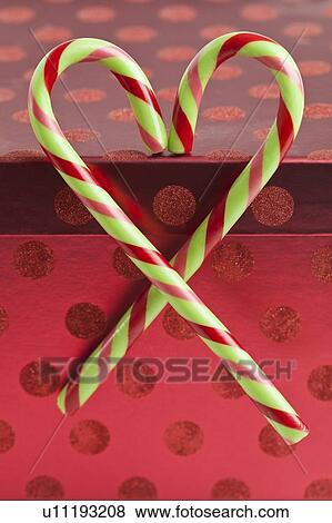 Stock Photo - Peppermint candy canes in heart shape, studio shot. Fotosearch