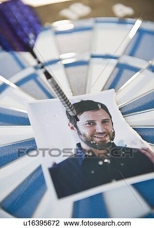 Photograph of man stuck with darts View Large Photo Image Stock Image - Photograph of man stuck with darts. Fotosearch