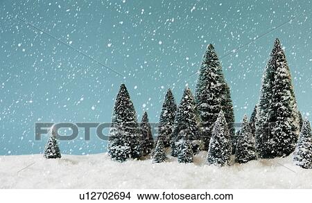 Picture - Pine trees covering by snow, studio shot. Fotosearch