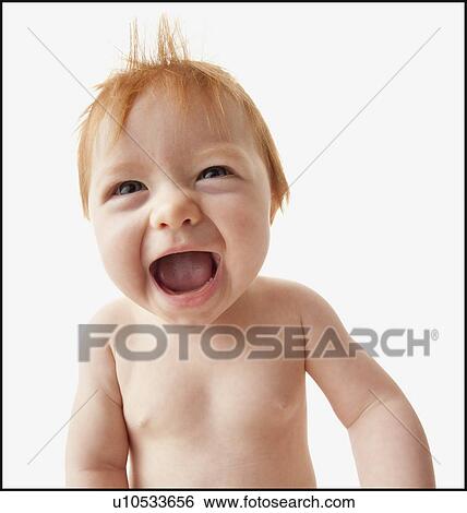Stock Photograph - Portrait of baby girl (6-11 months) laughing, studio shot. Fotosearch