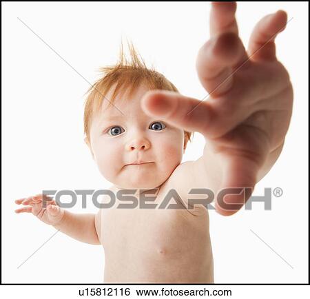 Stock Photograph - Portrait of baby girl (6-11 months), studio shot. Fotosearch