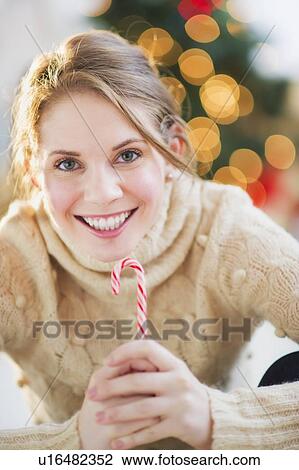Stock Image - Portrait of beautiful woman wearing wooly sweater. Fotosearch