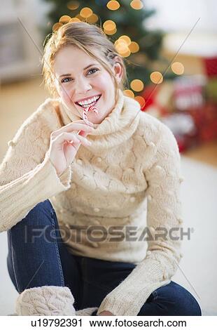 Stock Image - Portrait of beautiful woman wearing wooly sweater. Fotosearch