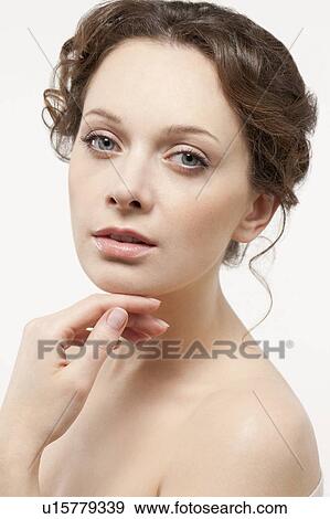 Stock Photo - Portrait of beautiful young woman, studio shot. Fotosearch