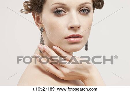 Stock Photo - Portrait of beautiful young woman, studio shot. Fotosearch