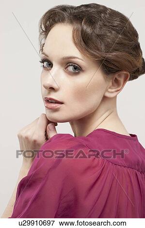 Stock Photo - Portrait of beautiful young woman, studio shot. Fotosearch