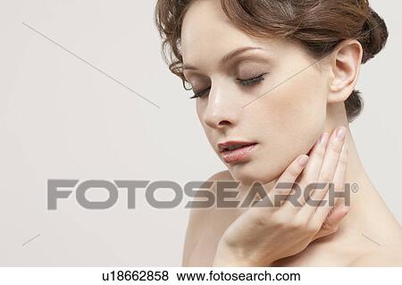Portrait of beautiful young woman with eyes closed, studio shot View Large Photo Image Stock Photo - Portrait of beautiful young woman with eyes closed, studio shot. Fotosearch