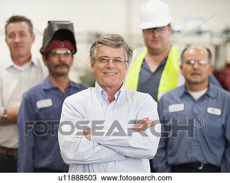 Portrait of businessman and workers in factory View Large Photo Image Stock Image - Portrait of businessman and workers in factory. Fotosearch