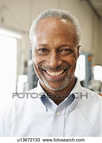 Portrait of businessman in warehouse View Large Photo Image Stock Image - Portrait of businessman in warehouse. Fotosearch