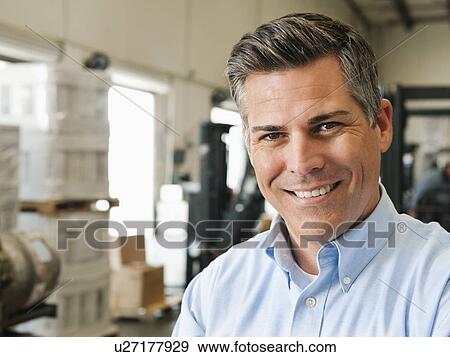 Stock Photo - Portrait of businessman in warehouse. Fotosearch