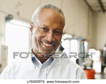 Portrait of businessman in warehouse View Large Photo Image Stock Photography - Portrait of businessman in warehouse. Fotosearch