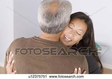 Stock Image - Portrait of couple embracing. Fotosearch