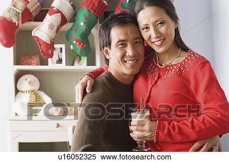 Portrait of couple enjoying christmas time View Large Photo Image Stock Photography - Portrait of couple enjoying christmas time. Fotosearch