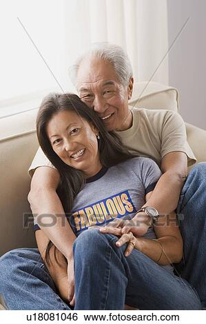 Portrait of couple relaxing on sofa View Large Photo Image Stock Photograph - Portrait of couple relaxing on sofa. Fotosearch