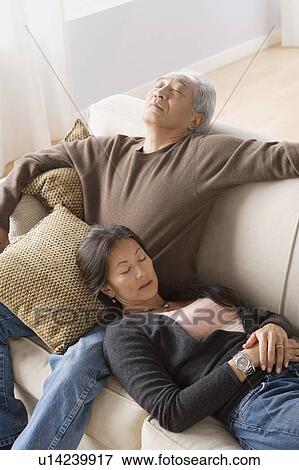 Stock Photo - Portrait of couple resting on sofa. Fotosearch