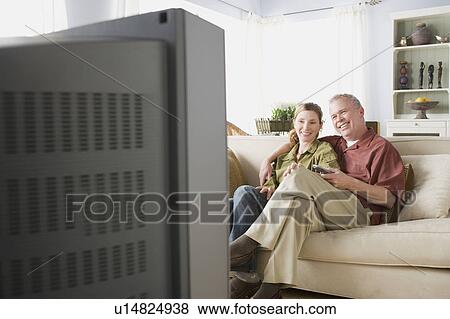 Portrait of couple watching tv View Large Photo Image Stock Photo - Portrait of couple watching tv. Fotosearch