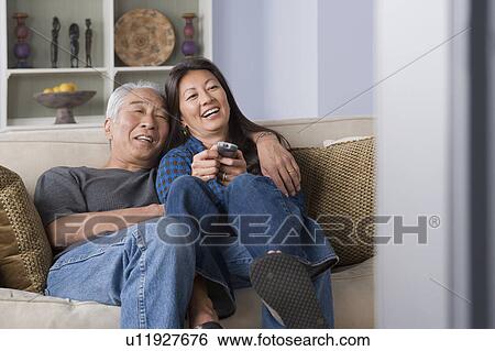Portrait of couple watching tv View Large Photo Image Stock Photograph - Portrait of couple watching tv. Fotosearch