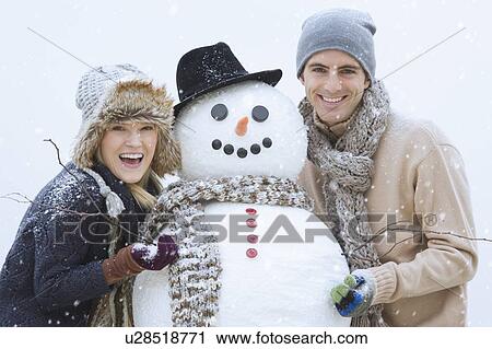 Portrait of couple with snowman View Large Photo Image Stock Image - Portrait of couple with snowman. Fotosearch