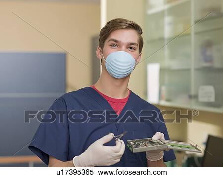 Portrait of dentist holding dental tools View Large Photo Image Stock Photography - Portrait of dentist holding dental tools. Fotosearch