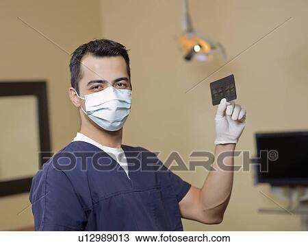 Portrait of dentist holding x-ray View Large Photo Image Stock Image - Portrait of dentist holding x-ray . Fotosearch