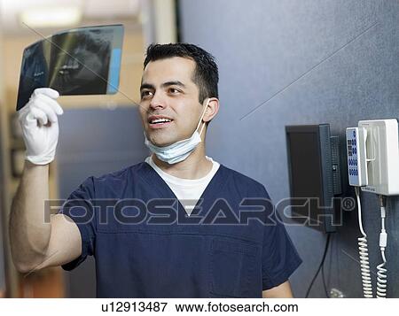 Portrait of dentist holding x-ray View Large Photo Image Stock Photo - Portrait of dentist holding x-ray . Fotosearch