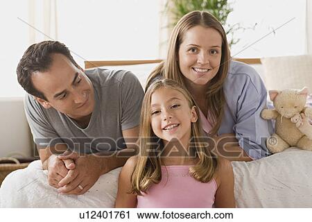 Stock Image - Portrait of family with daughter. Fotosearch