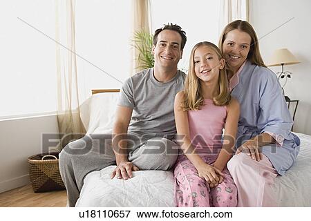 Stock Photo - Portrait of family with daughter. Fotosearch