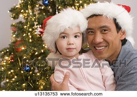 Portrait of father and daughter at Christmas tree View Large Photo Image Stock Image - Portrait of father and daughter at Christmas tree. Fotosearch