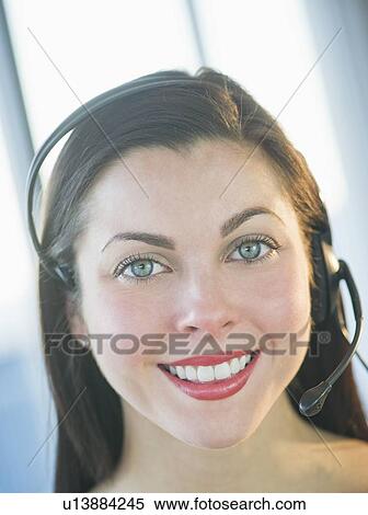 Stock Photography - Portrait of female customer service representative. Fotosearch