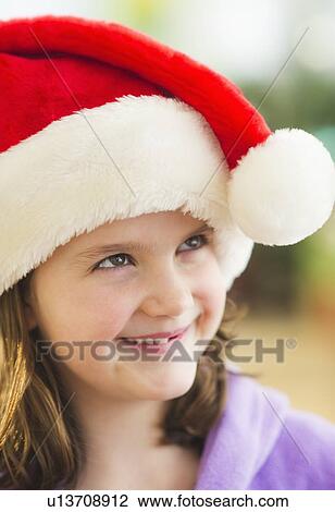 Portrait of girl (8-9) wearing santa hat View Large Photo Image Stock Image - Portrait of girl (8-9) wearing santa hat. Fotosearch