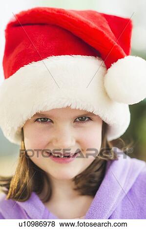 Portrait of girl (8-9) wearing santa hat View Large Photo Image Stock Photo - Portrait of girl (8-9) wearing santa hat. Fotosearch