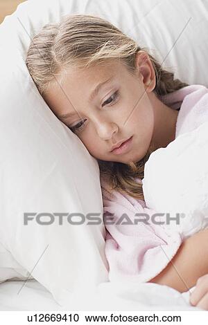 Portrait of girl laying in bed View Large Photo Image Stock Image - Portrait of girl laying in bed. Fotosearch