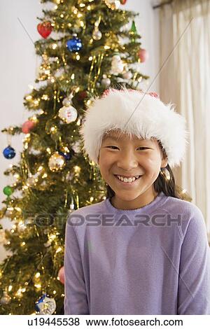 Portrait of girl wearing santa hat View Large Photo Image Stock Photo - Portrait of girl wearing santa hat. Fotosearch