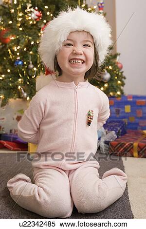 Stock Photography - Portrait of girl with presents at Christmas morning. Fotosearch