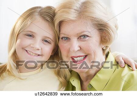 Stock Photo - Portrait of grandmother with granddaughter (8-9). Fotosearch