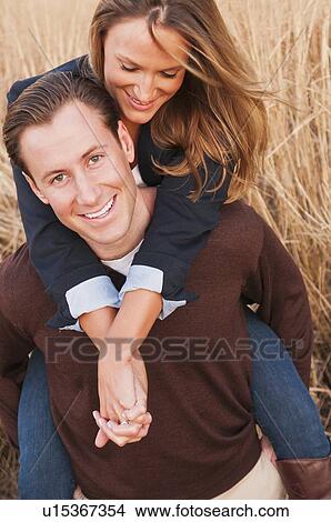 Portrait of happy young couple on wheat field View Large Photo Image Picture - Portrait of happy young couple on wheat field. Fotosearch