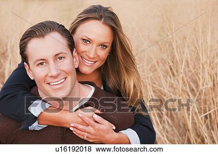 Portrait of happy young couple on wheat field View Large Photo Image Stock Photo - Portrait of happy young couple on wheat field. Fotosearch