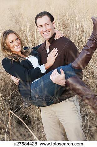 Portrait of happy young couple on wheat field View Large Photo Image Stock Photo - Portrait of happy young couple on wheat field. Fotosearch