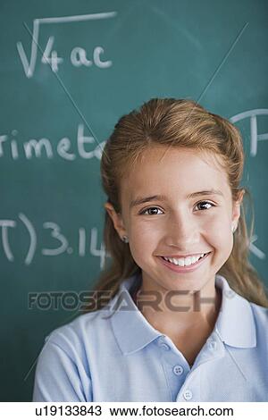 portrait of happy young girl against blackboard View Large Photo Image Stock Image - portrait of happy young girl against blackboard. Fotosearch