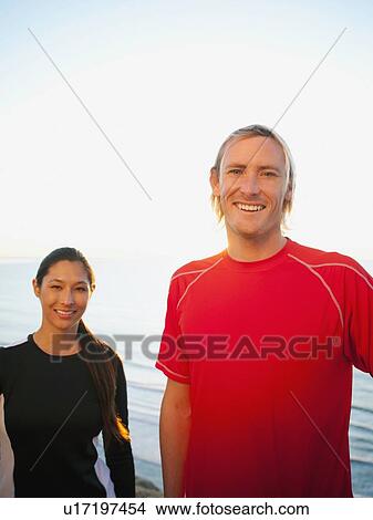 Picture - Portrait of male and female joggers at sea. Fotosearch