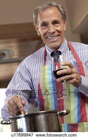 Portrait of man cooking and drinking wine View Large Photo Image Stock Photo - Portrait of man cooking and drinking wine. Fotosearch