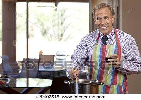 Portrait of man cooking and drinking wine View Large Photo Image Stock Photography - Portrait of man cooking and drinking wine. Fotosearch