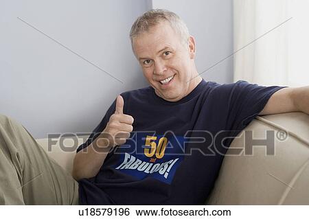 Stock Photograph - Portrait of man with thumb up. Fotosearch