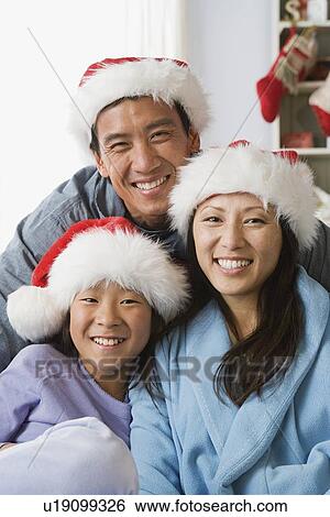 Stock Photograph - Portrait of mother and father with daughter. Fotosearch
