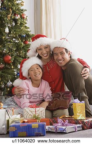 Portrait of parents with daughter (10-11) at Christmas tree View Large Photo Image Stock Image - Portrait of parents with daughter (10-11) at Christmas tree. Fotosearch