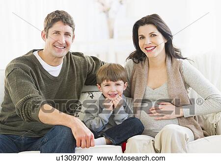 Portrait of parents with son (4-5) on sofa View Large Photo Image Stock Photo - Portrait of parents with son (4-5) on sofa. Fotosearch