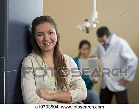 Picture - Portrait of patient, dentists in background. Fotosearch