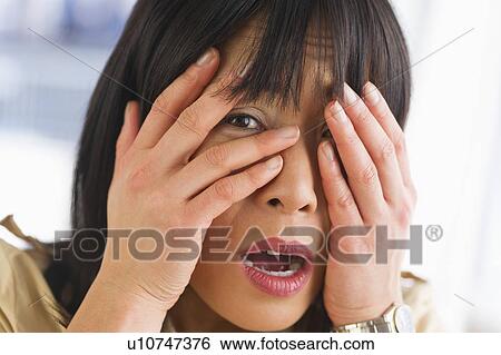 Stock Photograph - Portrait of scared woman. Fotosearch